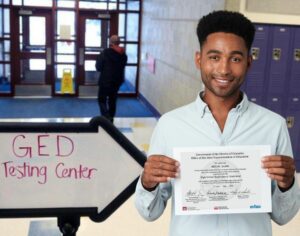 man holding certificate at GED testing center